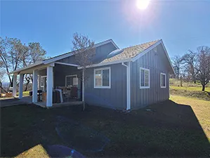 Front view of a modern two-story home with freshly installed James Hardie™ HardiePlank® siding in Arctic White, featuring clean trim and new windows.