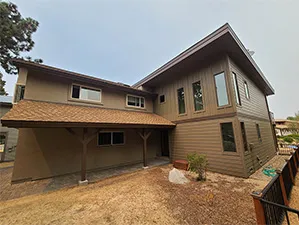 Front view of a modern two-story home with freshly installed James Hardie™ HardiePlank® siding in Arctic White, featuring clean trim and new windows.