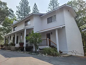 Front view of a modern two-story home with freshly installed James Hardie™ HardiePlank® siding in Arctic White, featuring clean trim and new windows.