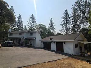 Front view of a modern two-story home with freshly installed James Hardie™ HardiePlank® siding in Arctic White, featuring clean trim and new windows.