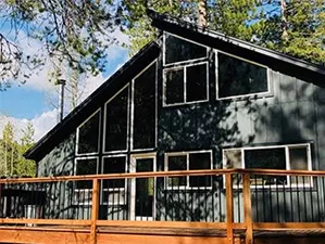 Front view of a modern two-story home with freshly installed James Hardie™ HardiePlank® siding in Arctic White, featuring clean trim and new windows.