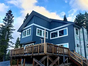 Front view of a modern two-story home with freshly installed James Hardie™ HardiePlank® siding in Arctic White, featuring clean trim and new windows.