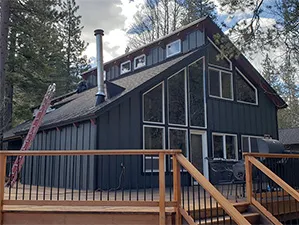 Front view of a modern two-story home with freshly installed James Hardie™ HardiePlank® siding in Arctic White, featuring clean trim and new windows.