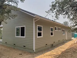 Front view of a modern two-story home with freshly installed James Hardie™ HardiePlank® siding in Arctic White, featuring clean trim and new windows.