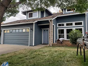 Front view of a modern two-story home with freshly installed James Hardie™ HardiePlank® siding in Arctic White, featuring clean trim and new windows.