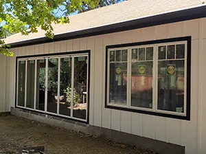 Front view of a modern two-story home with freshly installed James Hardie™ HardiePlank® siding in Arctic White, featuring clean trim and new windows.