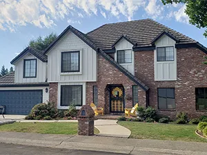 Front view of a modern two-story home with freshly installed James Hardie™ HardiePlank® siding in Arctic White, featuring clean trim and new windows.