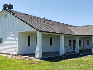 Front view of a modern two-story home with freshly installed James Hardie™ HardiePlank® siding in Arctic White, featuring clean trim and new windows.