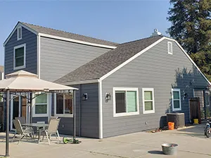 Front view of a modern two-story home with freshly installed James Hardie™ HardiePlank® siding in Arctic White, featuring clean trim and new windows.
