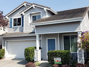Front view of a modern two-story home with freshly installed James Hardie™ HardiePlank® siding in Arctic White, featuring clean trim and new windows.