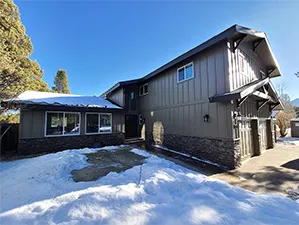 Front view of a modern two-story home with freshly installed James Hardie™ HardiePlank® siding in Arctic White, featuring clean trim and new windows.