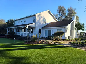 Front view of a modern two-story home with freshly installed James Hardie™ HardiePlank® siding in Arctic White, featuring clean trim and new windows.